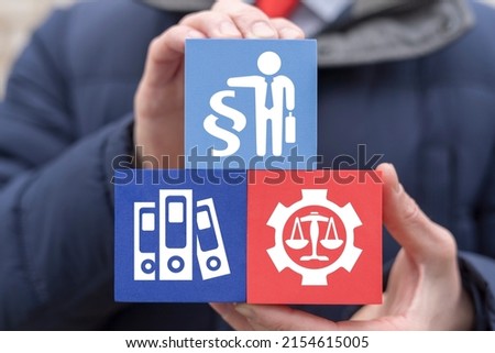 Concept of law regulations. Businessman or lawyer holding styrofoam blocks with man and paragraph symbol and other legal signs.