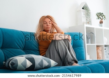 Unhappy woman depressed touching hair, sitting on floor at home, thinking about problems, upset girl feeling lonely and sad, psychological and mental troubles, suffering Royalty-Free Stock Photo #2154617989