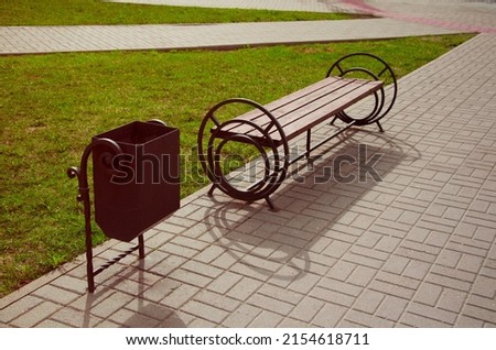 Bench and rubbish bin in the park, top view. A place of rest for tourists and pedestrians on the city street. Royalty-Free Stock Photo #2154618711