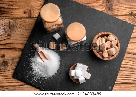 White sugar and brown sugar background. Sweet and tasty. Healthy and unhealthy lifestyle. 