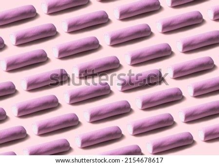Pink marshmallows pattern on pink paper background. Geometric pattern of white marshmallows on color background.