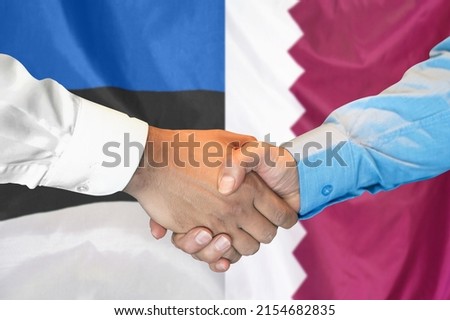 Business handshake on background of two flags. Men handshake on background of Estonia and Qatar flag. Support concept
