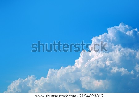 Light cloudy, good weather. White clouds in the blue sky. Summer sky. Heaven and infinity. Curly clouds on a sunny day. Beautiful bright blue background.