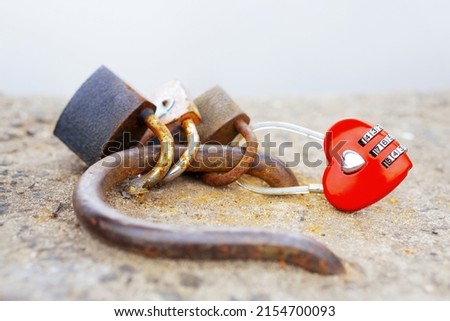 Heart-shaped red combination lock outdoors. Everlasting love and friendship symbol.