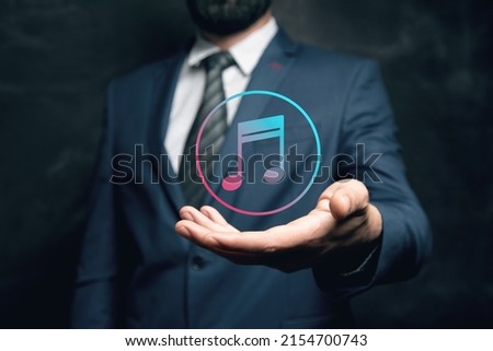 musical icon. Man holding in his hand