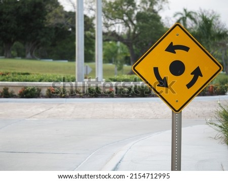 Sign For Roundabout, around flagpoles center island, Traffic Roundabout Sign, road and signs.
