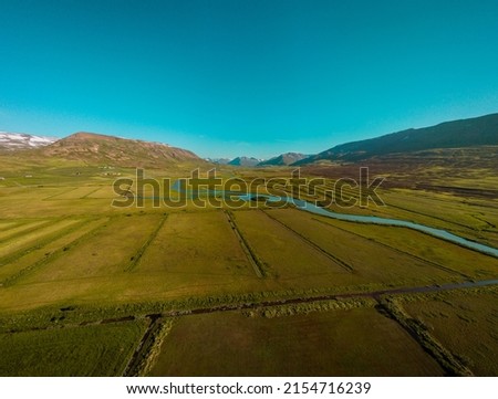 Beautiful valley of Miklavatn lake close to Haganes with aerial drone view of river delta and beautiful Icelandic hills and mountains in the background.