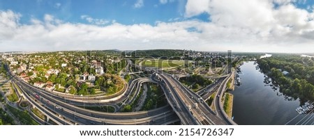 Aerial skyline cityscape view of Belgrade, Serbia, in the morning. Aerial  drone view of   Ada Ciganlija lake, hippodrome and traffic driving over intersection in Belgrade. Urban scene Royalty-Free Stock Photo #2154726347