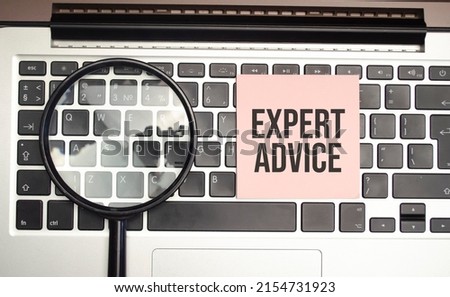 Expert advice word on the pink sticker and laptop