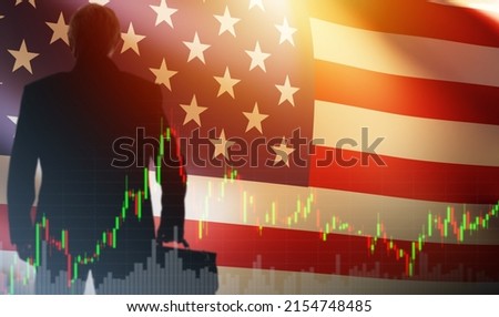 American business. US investments. USA trading, American stock exchange. Businessman stands with his back against the background of the flag of United States of America. Investor and stock quotes. Royalty-Free Stock Photo #2154748485