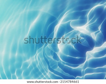 Reflection​ on​ surface​ blue​ water​ in​ the​ sea. Abstract​ of​ surface​ blue​ water​ for​ background. Closeup​ abstract​ of​ surface​ blue​ water. Splash​ed​ water​ in the​ sea​ for​ background.
