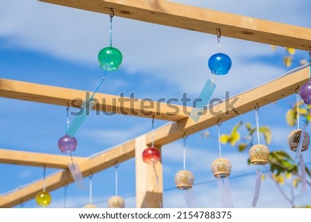 Blue sky and colorful wind chimes.