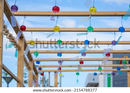 Blue sky and colorful wind chimes.