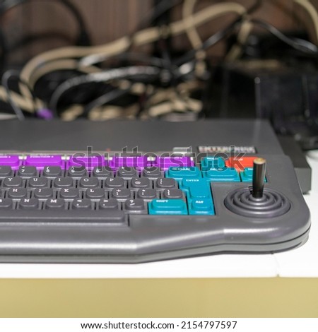 Element of an old and obsolete computer. Keyboard with joystick. Close up.