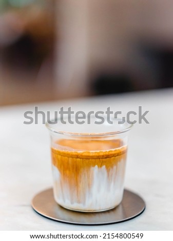 Coffee dirty menu - A glass of espresso shot mixed with cold fresh milk in coffee shop cafe and restaurant.vertical coffee dirty picture in cafe.specialty coffee.food beverage menu.japan drink idea.