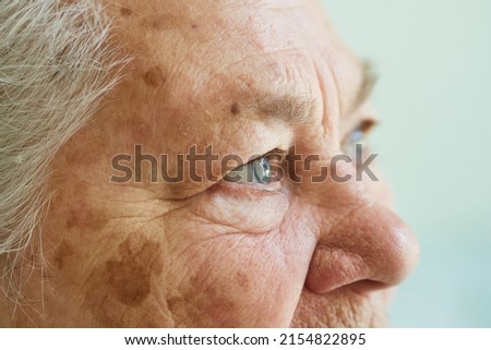 Profile view of the face of a gray-haired elderly woman, 80 years old, with wrinkles, age spots on the skin Royalty-Free Stock Photo #2154822895
