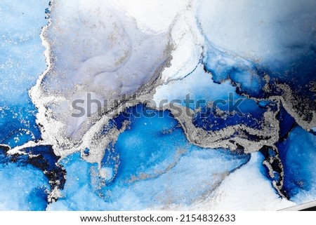 Blue silver abstract background of marble liquid ink art painting on paper . Image of original artwork watercolor alcohol ink paint on high quality paper texture .