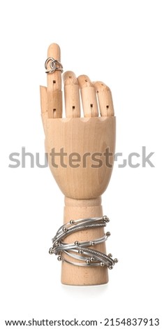 Wooden hand with stylish jewellery on white background