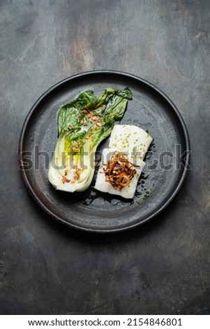 Tasty fried halibut fillet with bok choi, restaurant dish, top view, copy space