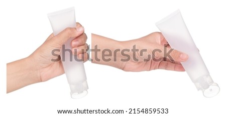Set of Hand holding blank squeeze bottle plastic tube isolated on white background. Royalty-Free Stock Photo #2154859533