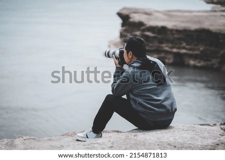 Professional photographer taking picture in nature.