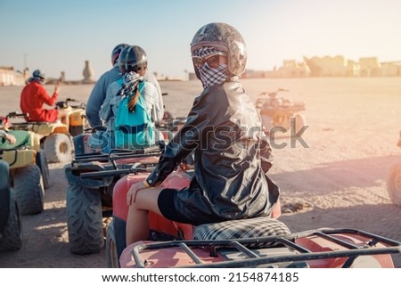 Woman tourist on quad bike ATV safari in desert Sharm Hurghada, Egypt.