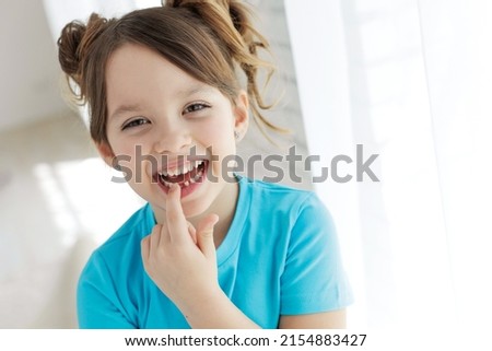 The kid lost a tooth. Baby without a tooth. Portrait of a little girl no tooth. High quality photo Royalty-Free Stock Photo #2154883427