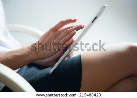 Woman using a tablet computer. Close up.