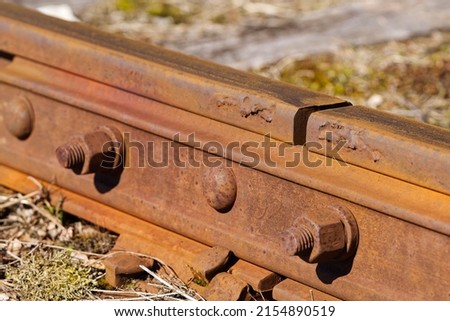 Broken Connecting two rails. with visible bolts. Train tracks underlay, rails and crushed stones Gap Between Rails at Fishplate