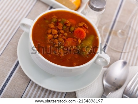 Traditional Spanish lentil soup with vegetables, which has an original rich taste and useful properties