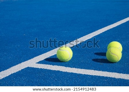 Selective focus. Three balls an the net of a paddle tennis court Royalty-Free Stock Photo #2154912483