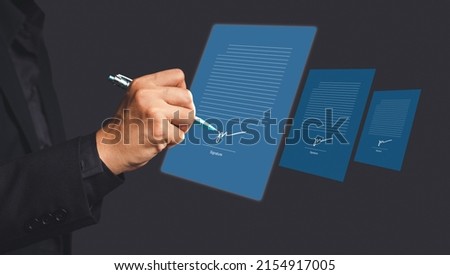 Electronic signature and paperless office concept. A businessman uses a pen to sign electronic documents on digital documents on a virtual screen. E-signing. Technology and document management