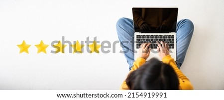 Customer experience concept. Top View of woman sitting on the floor and using computer laptop