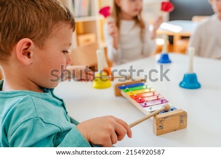 Kindergarten Children Learning Music Using Various Colorful  Instruments. Learning Music for Kids using Colors. Montessori Music Activities for Preschoolers. Royalty-Free Stock Photo #2154920587