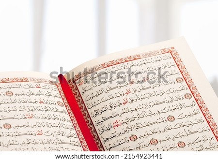 Opened Quran book for Muslim to recites as a devotion to God. Royalty-Free Stock Photo #2154923441