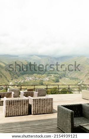 Outdoor picture of beautiful nature with mountains in sunlight. Wood terrace with view on gorge of mountains. Location place georgian mountains, Europe. Artistic picture. Beauty world. 