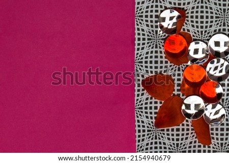 black and white wallpaper with 3d beads on it that reflect colors and a few red petals, on the left red background as copy space, creative love design