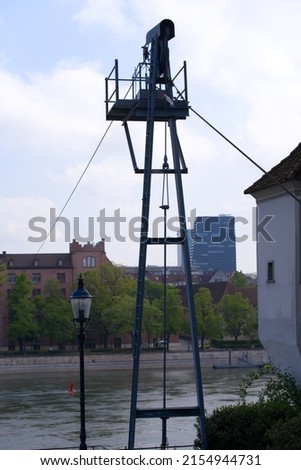 Iron tower with metal cable for ferry crossing over Rhine River at City of Basel on a blue cloudy spring day. Photo taken April 27th, 2022, Basel, Switzerland.
