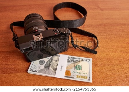 Bundle of dollars with the inscription hobby and camera. Hobby money concept.
