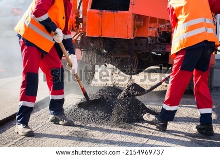Street resurfacing. Fresh asphalt construction. Bad road Royalty-Free Stock Photo #2154969737