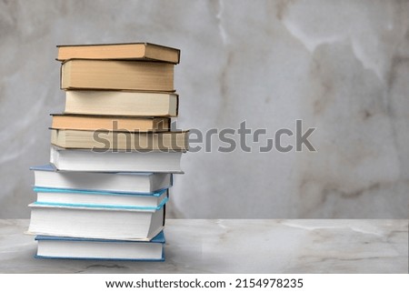Stack of books on wooden desk