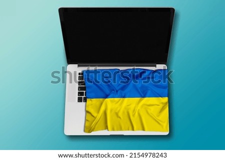 Laptop on ukrainian flag and . War in Ukraine, Internet information
