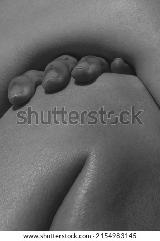 Hand on knee. Detailed texture of human female skin. Close up part of woman's body. Skincare, bodycare, healthcare, hygiene concept. Macro. Design for abstract artwork, picture, poster Royalty-Free Stock Photo #2154983145