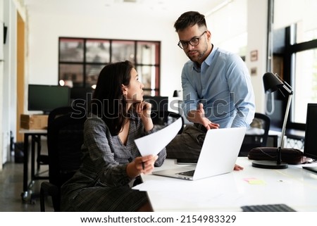 Colleagues in office. Businesswoman and businessman discussing work in office	 Royalty-Free Stock Photo #2154983329