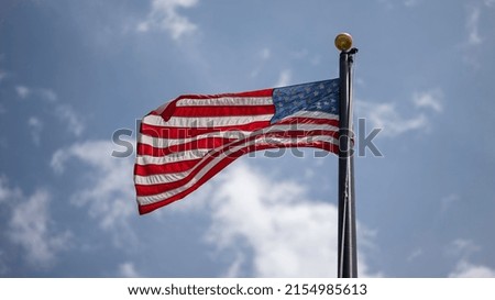 The waving American flag on a pole