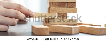 Planning to reduce investment risks, plan and strategy in business, Establishing a business risk mitigation plan to create stability for the company, Business growth with wooden blocks concept. Royalty-Free Stock Photo #2154996705