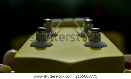 guitar neck with strings in the light 