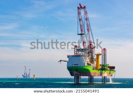 Offshore wind construction vessel at work Royalty-Free Stock Photo #2155041491