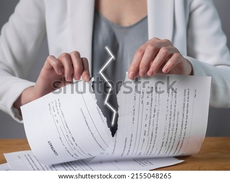 Torn contract in hands. Deal cancel. Sanctions, agreement conditions and terms violation consequences. Cooperation termination. Refusal to renew agreement. High quality photo Royalty-Free Stock Photo #2155048265