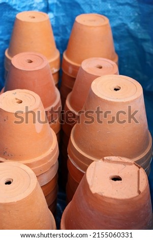Clay flower pots in a blue bag showing their bottoms